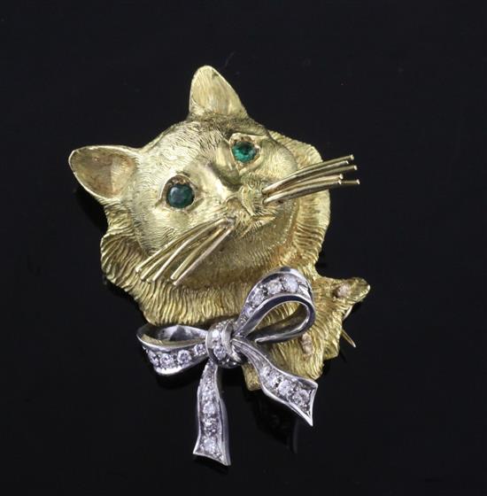 A gold, diamond and emerald set novelty clip brooch, modelled as the face of a cat, 1.75in.